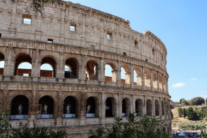 Close-up of the Colosseum's arched facade in Rome with clear blue sky. — Julius Caesar The Man Who Changed Rome Forever